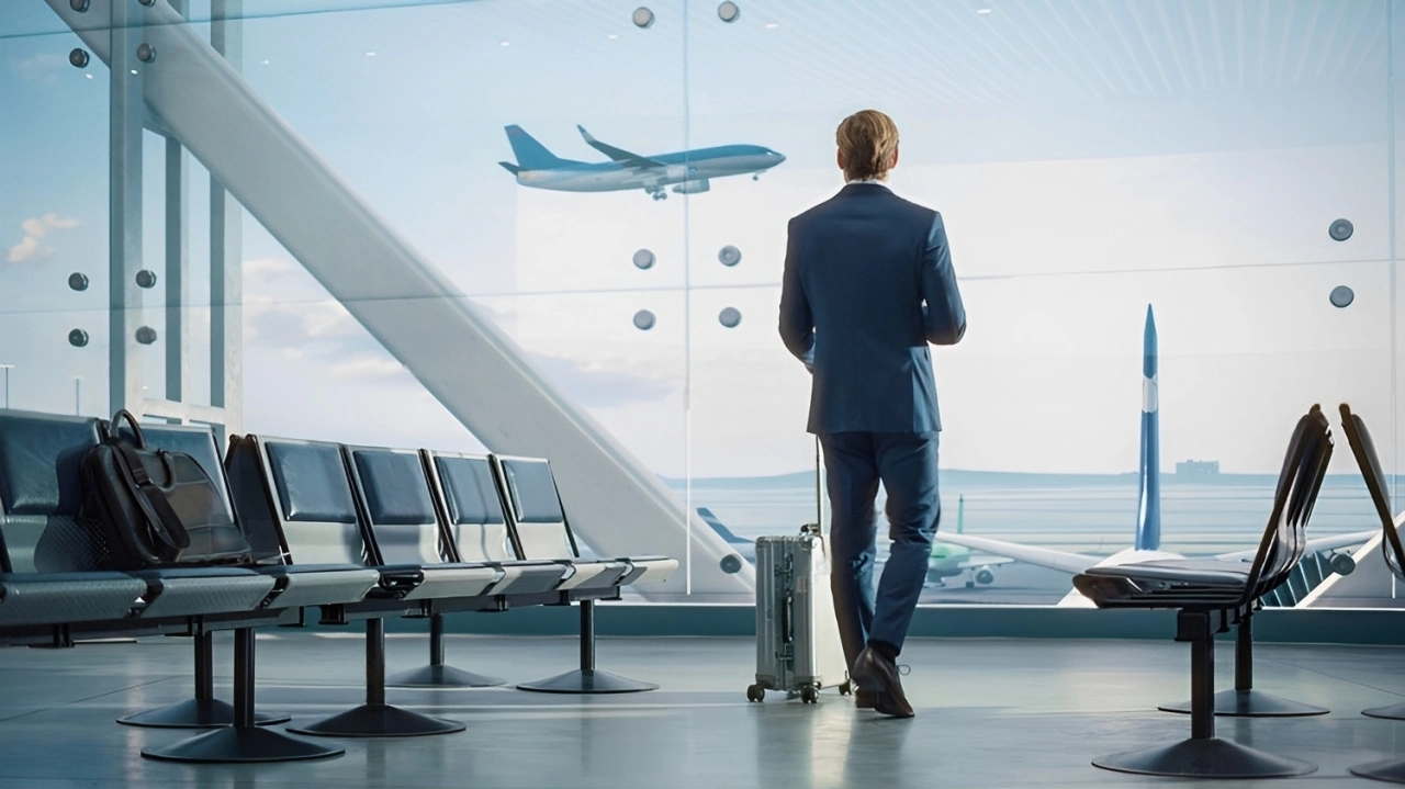 airport-terminal-businessman-rolling-suitcase-walks-2137645249